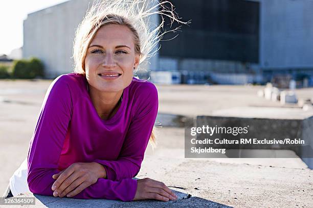 woman leaning on concrete blocks - refshaleøen stock pictures, royalty-free photos & images