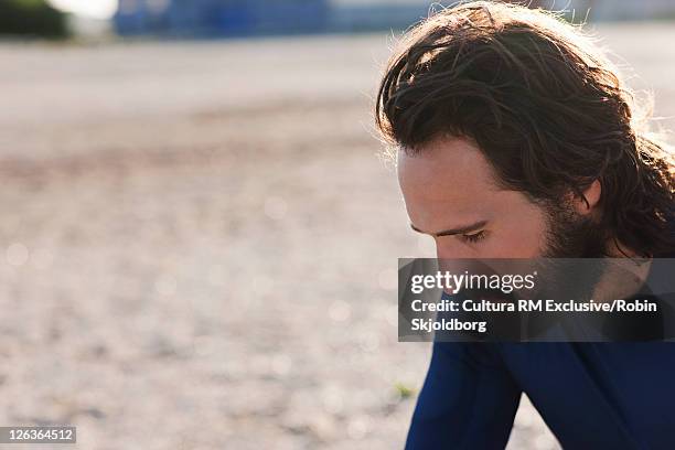 man sitting in industrial area - refshaleøen stock pictures, royalty-free photos & images