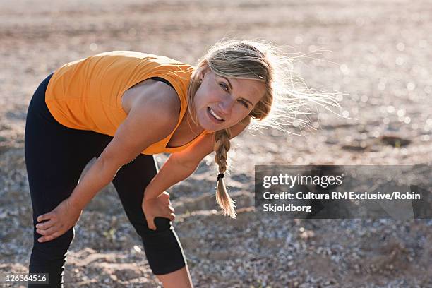 runner resting on rocky beach - refshaleøen stock pictures, royalty-free photos & images