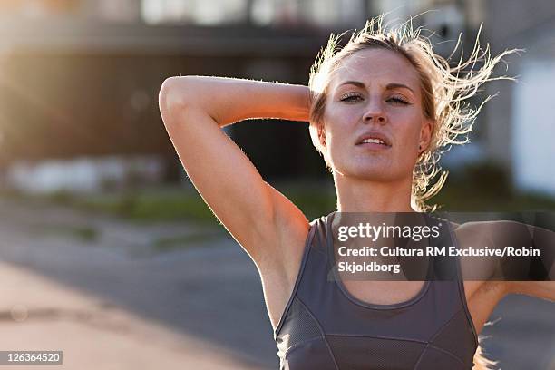 woman pushing her hair back - refshaleøen stock pictures, royalty-free photos & images