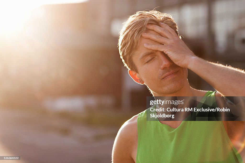 Man pushing his hair back