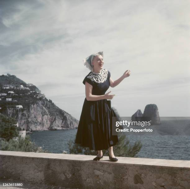 English actress and singer Gracie Fields rehearses on a wall at La Canzone del Mare on the Isle of Capri, Italy in October 1952.