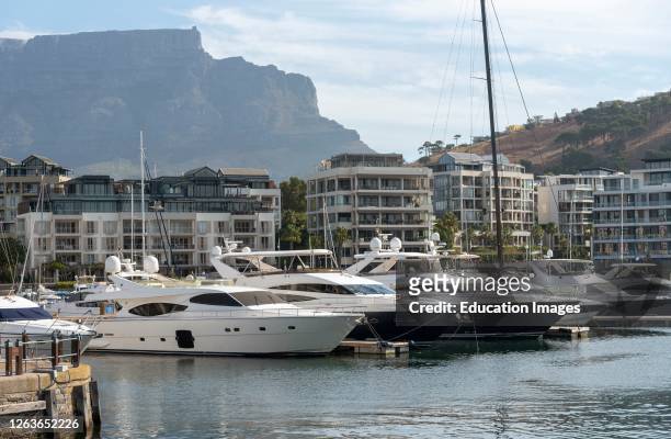Cape Town, South Africa, Luxury yachts and properties on the waterfront with a background of Table Mountain central Cape Town, South Africa.