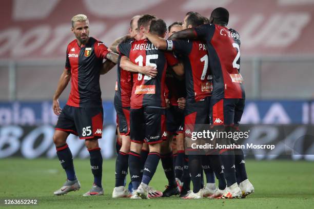 Cristian Romero of Genoa CFC celebrates with team mates after heading the ball into the net to give the side a 3-0 lead during the Serie A match...