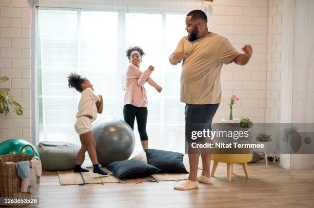 african father and his two daughter morning exercise at home. - family wellbeing stock pictures, royalty-free photos & images