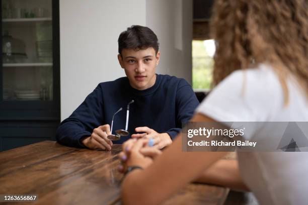 teenage boy chatting to his friend - boy and girl talking stock pictures, royalty-free photos & images