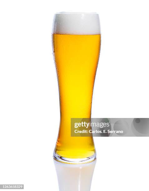 glass of beer with a foam head - beer glass stock-fotos und bilder