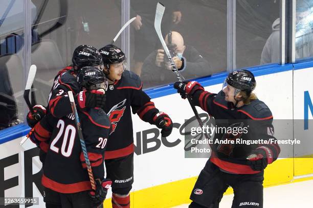 Andrei Svechnikov of the Carolina Hurricanes celebrates with Sebastian Aho, Teuvo Teravainen and Sami Vatanen after scoring a goal against the New...