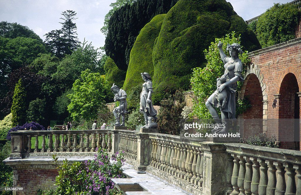 A view of some of the ornate statues contained within the picturesque gardens surrounding Powys Castle. Most of the great Welsh castles were allowed to decay when the medieval wars ended, but Powis survives as a captivating example of a military stronghold