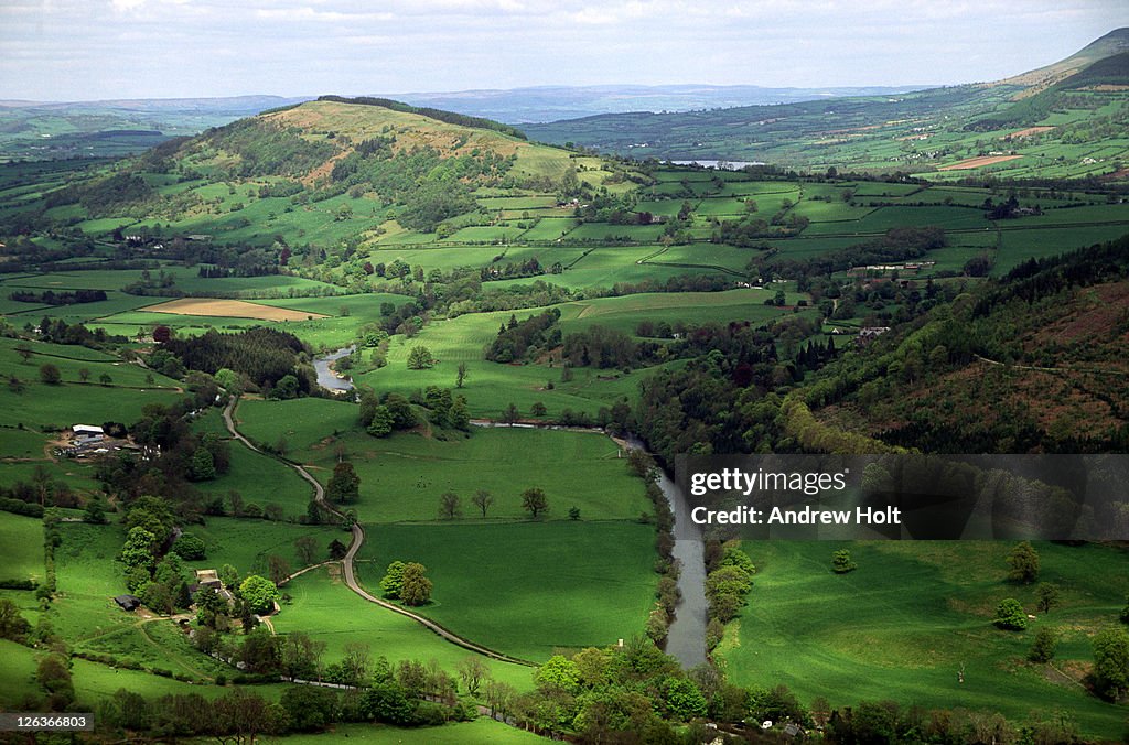 The river Usk winding its way through the Welsh countryside. The river Usk, Afon Wysg in Welsh, rises in the mountains of mid-Wales then flows south-east through Abergavenny and the eponymous town of Usk to the Roman legionary fortress of Caerleon and the