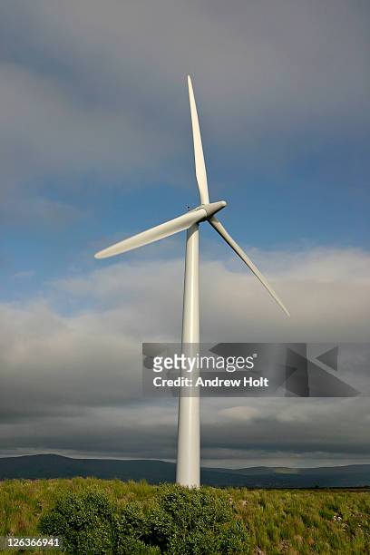 a wind turbine on top of a hill in altahullion in northern ireland, generating renewable and pollution-free energy. - derry northern ireland stock pictures, royalty-free photos & images