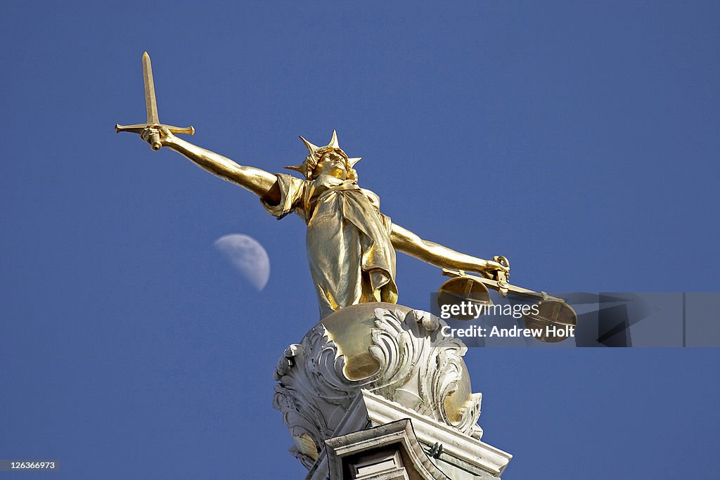 The statue of Justice at The Old Bailey, London. With a sword in one hand and scales in the other this statue of justice on top of the Old Bailey has one difference to many other similar pieces - in this case Justice herself has no blindfold. The sword sta