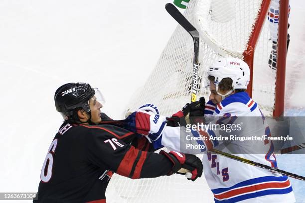 Brady Skjei of the Carolina Hurricanes and Brett Howden of the New York Rangers fight in Game Two of the Eastern Conference Qualification Round prior...