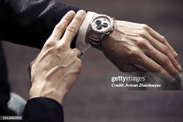 hands of businessman in formal wear with luxurious wristwatch - luxury watch stock pictures, royalty-free photos & images