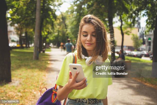 happy beautiful young high school girl with white smart phone - kyiv summer stock pictures, royalty-free photos & images