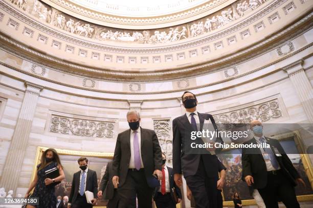 Wearing a face mask to reduce the risk of coronavirus, U.S. Treasury Secretary Steven Mnuchin and White House Chief of Staff Mark Meadows walk...