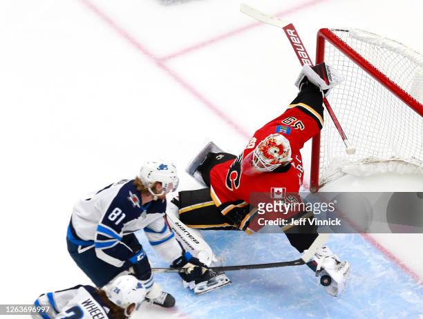 Cam Talbot of the Calgary Flames dives to stop a shot by Kyle Connor of the Winnipeg Jets during Game Two of the Western Conference Qualification...