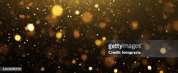 abstract golden defocused lights background - glamour stock-fotos und bilder