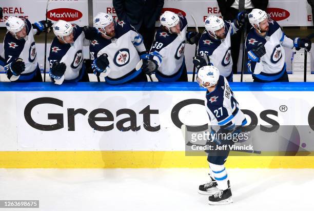 Nikolaj Ehlers of the Winnipeg Jets is congratulated by teammates on the bench after he scored a goal in the third period against the Calgary Flames...