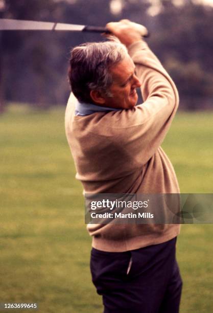 Sports Illustrated writer Dan Jenkins follows his shot during a celebrity golf event circa February, 1971.