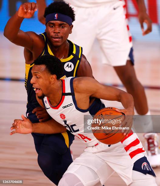 Ish Smith of the Washington Wizards drives the ball as Aaron Holiday of the Indiana Pacers defends at Visa Athletic Center at ESPN Wide World Of...