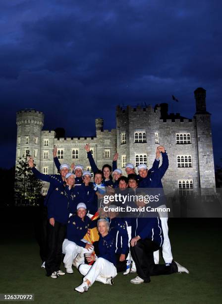 The European team celebrate with the trophy following their 15-13 victory during the singles matches on day three of the 2011 Solheim Cup at Killeen...