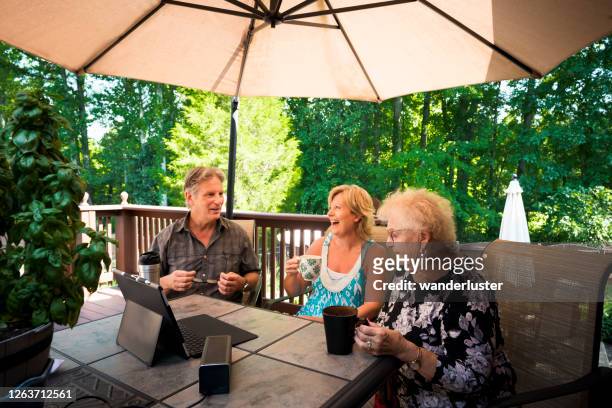 three adults interacting outdoors - indiana home stock pictures, royalty-free photos & images