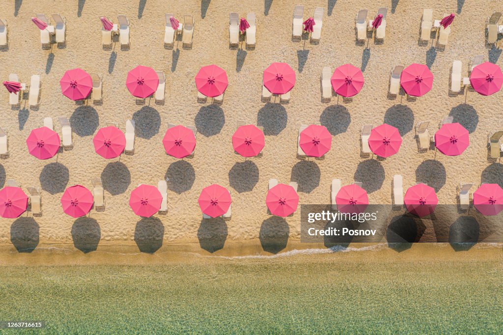 Sun umbrellas at empty beach in Afissos