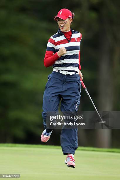 Michelle Wie of the USA celebrates holing a putt on the 17th green during the singles matches on day three of the 2011 Solheim Cup at Killeen Castle...