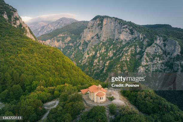 view to enipeus gorge over chapel of prophet elias at mount olympus national park near litochoro - olympus stock pictures, royalty-free photos & images