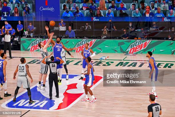 Jakob Poeltl of the San Antonio Spurs and Joel Embiid of the Philadelphia 76ers battle for the opening tip-off at Visa Athletic Center at ESPN Wide...