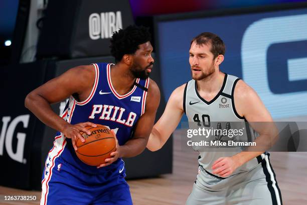 Joel Embiid of the Philadelphia 76ers is defended by Tyler Zeller of the San Antonio Spurs during the second quarter at Visa Athletic Center at ESPN...