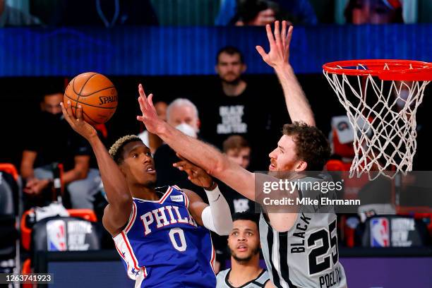 Josh Richardson of the Philadelphia 76ers attempts a shot against Jakob Poeltl of the San Antonio Spurs during the third quarter at Visa Athletic...