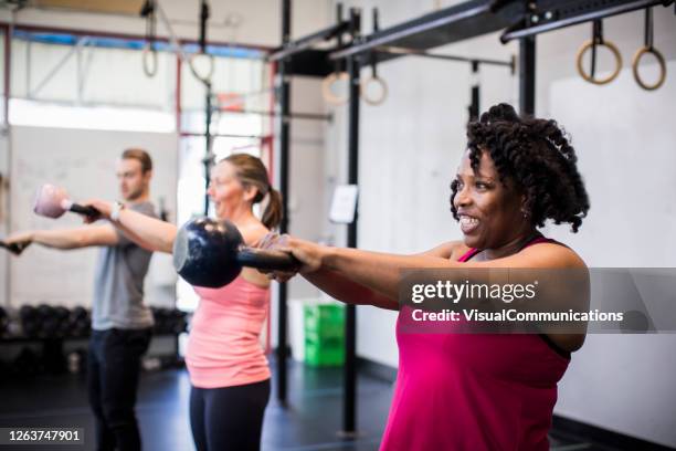athlete exercising with kettlebell in the gym. - gym reopening stock pictures, royalty-free photos & images