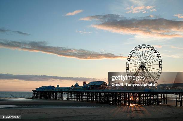 central pier at blackpool, in silhouette against the setting sun, in england's north east - blackpool stock pictures, royalty-free photos & images