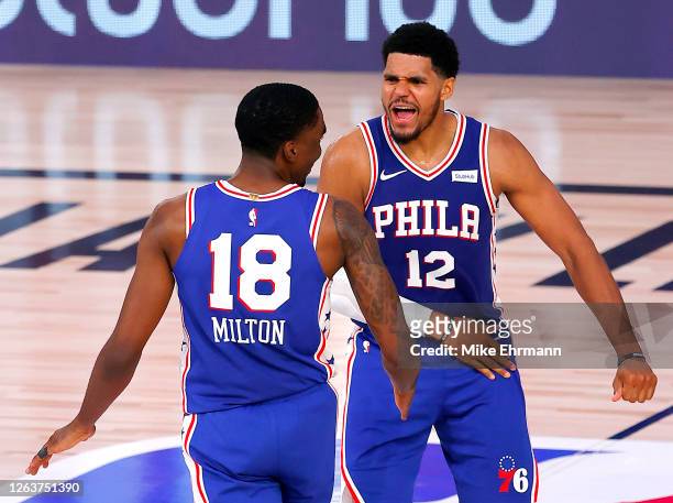 Shake Milton of the Philadelphia 76ers is congratulated by his teammate, Tobias Harris, after scoring a go-ahead three point basket against the San...