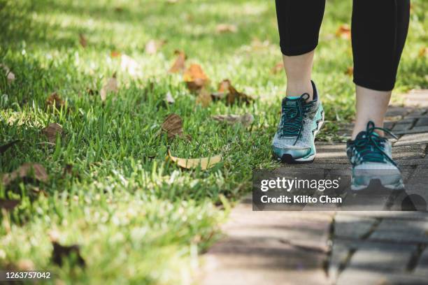 asian woman running in a park, closeup on the shoes - legs walking stock pictures, royalty-free photos & images