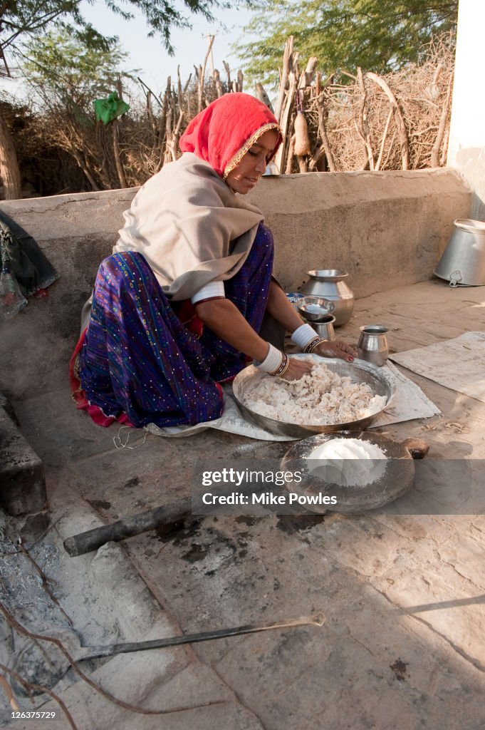 Bishnoi woman making roti (bread) in traditional way, Rajasthan, India