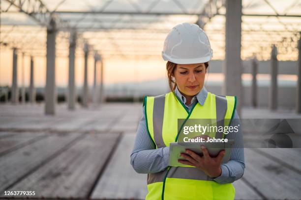 female construction engineer using tablet - examining plant stock pictures, royalty-free photos & images