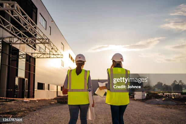 ingegneri donne che supervisionano il cantiere - solo donne foto e immagini stock