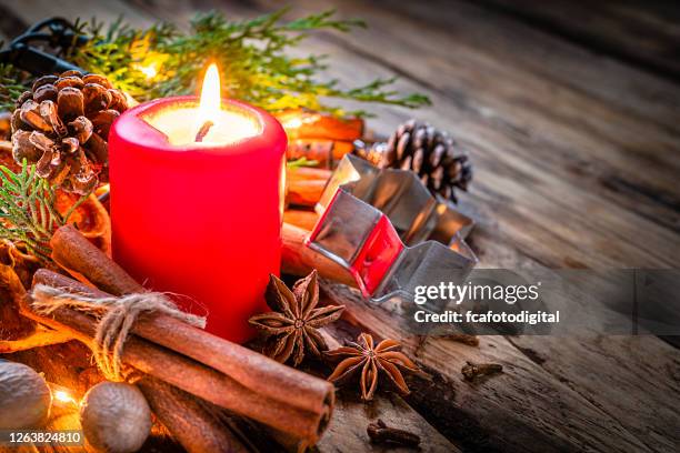 christmas spices and christmas candle on rustic wooden table. copy space - advent candle stock pictures, royalty-free photos & images