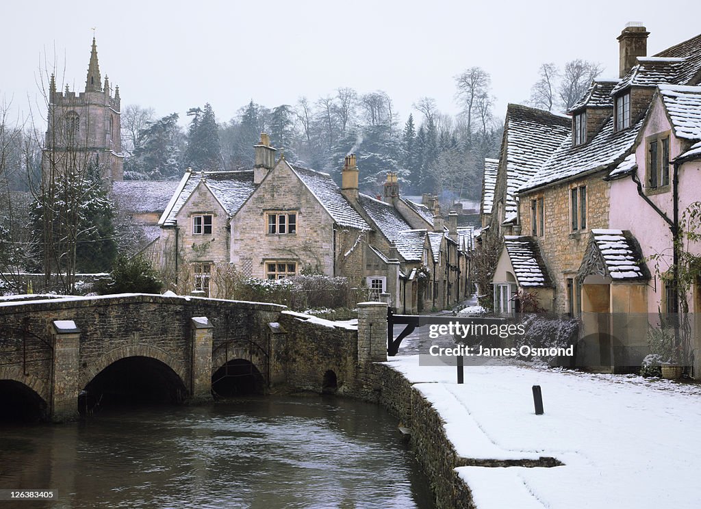 The small quintessential snow covered village of Castle Combe in Wiltshire.