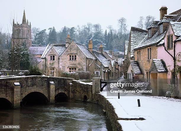 the small quintessential snow covered village of castle combe in wiltshire. - english village stock pictures, royalty-free photos & images