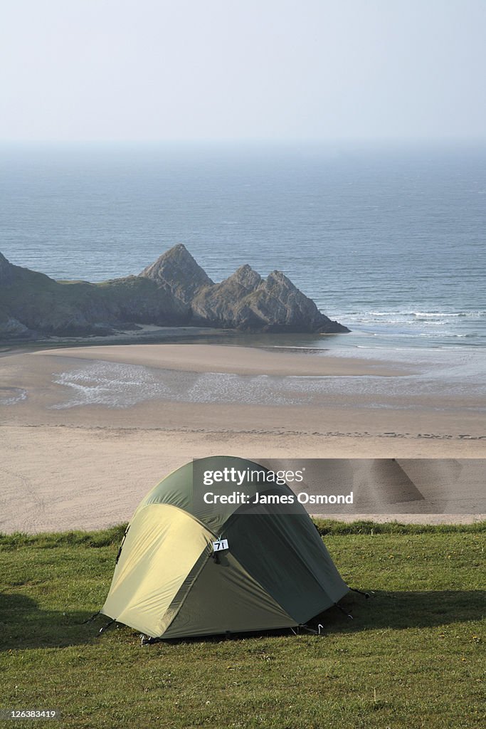 A tent pitched at Three Cliffs Bay Campsite on the Gower Peninsula, South Wales.