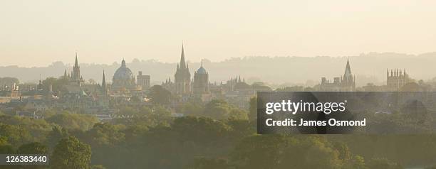 a misty view of oxford city skyline, oxfordshire. - oxford university stockfoto's en -beelden