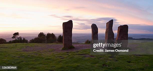 sunset over the four stones at the highest point of the clent hills near birmingham. - worcester england stock pictures, royalty-free photos & images