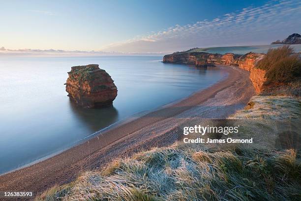 ladram bay at sunrise in winter. jurassic coast world heritage site. devon. england. uk. - devon stockfoto's en -beelden