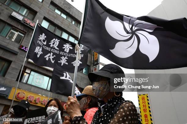 People participate in a rally to support Hong Kong pro-democracy protests in front of Chinese Embassy on August 04, 2020 in Seoul, South Korea....