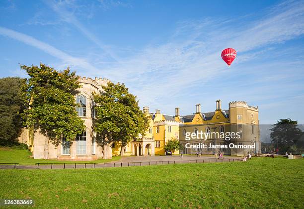 hot air balloon over ashton court house. bristol. england. uk. - bristol balloons stock pictures, royalty-free photos & images