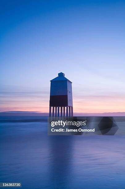 burnham-on-sea lighthouse at high tide at dusk. somerset. england. uk. - burnham on sea stock pictures, royalty-free photos & images